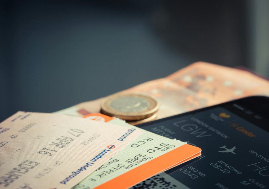 A plane flying over Nairobi at sunset, with flight deals and last-minute tickets shown below.